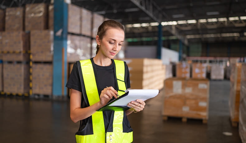 A women working in a warehouse setting